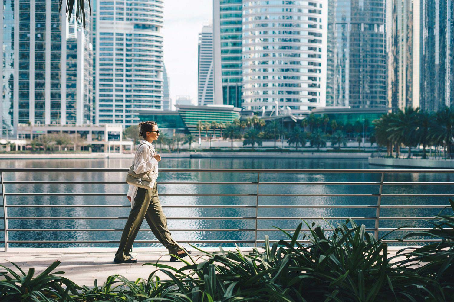 Woman walking with modern city background